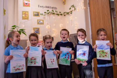 Six young children holding artwork